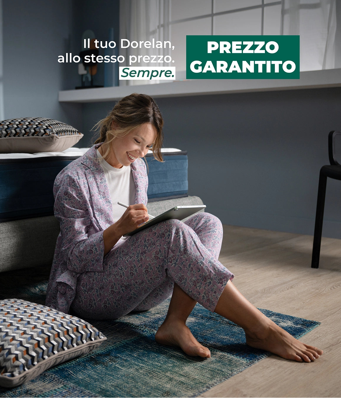 ragazza disegna su ipad di fianco ad un letto + materasso dorelan a prezzo garantito cons critta il tuo dorelan, allo stesso prezzo, sempre