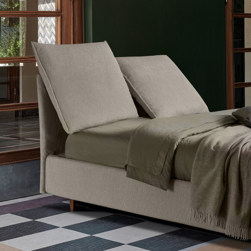 letto con testiera inclinabile e reclinabile, color beige con lenzuola color pistacchio. letto versatile da poter usare tutto il giorno, anche contenitore
